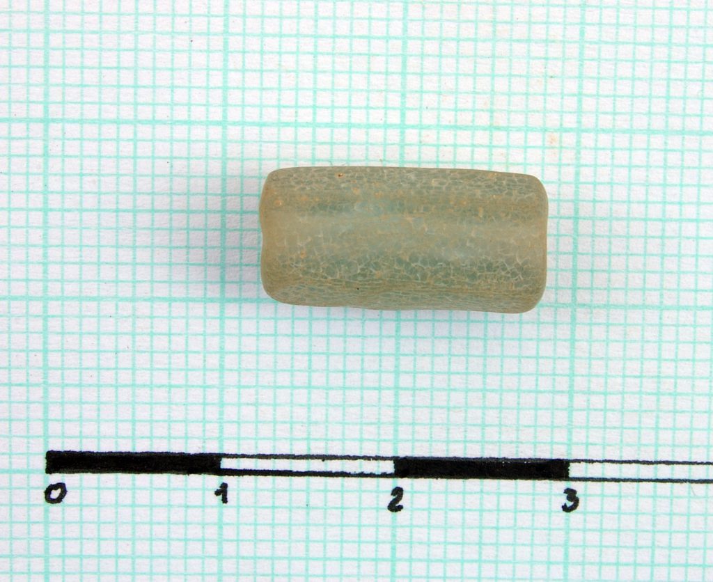 Cylindrical hexagonal perforated bead (glass?)