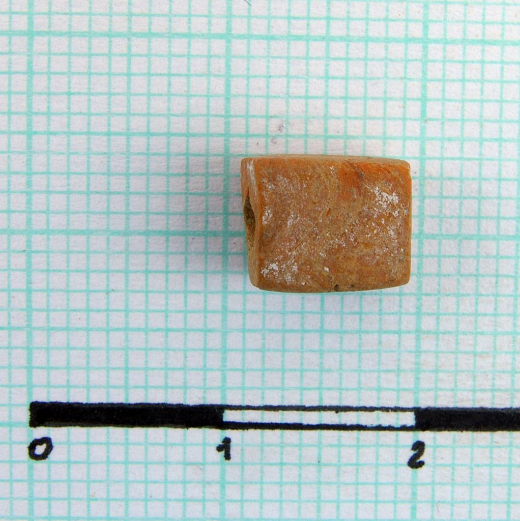 Block orange bead of fired clay